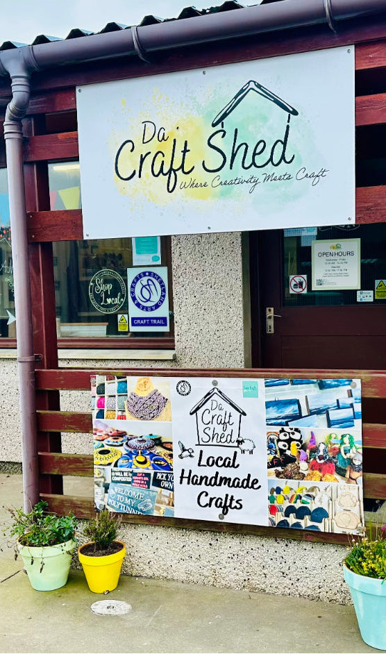 Da Craft Shed entrance with signs and plants outside