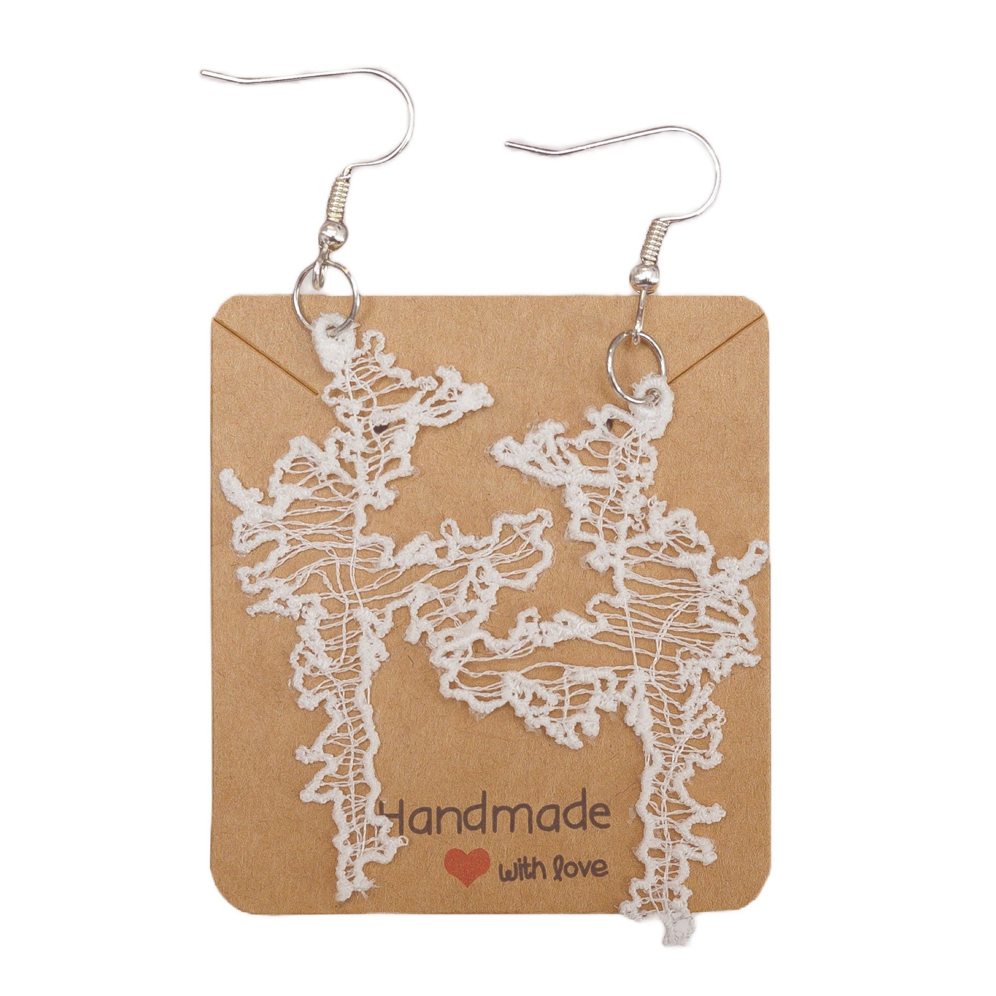 White Shetland Isle lace earrings with silver hooks on a brown card.