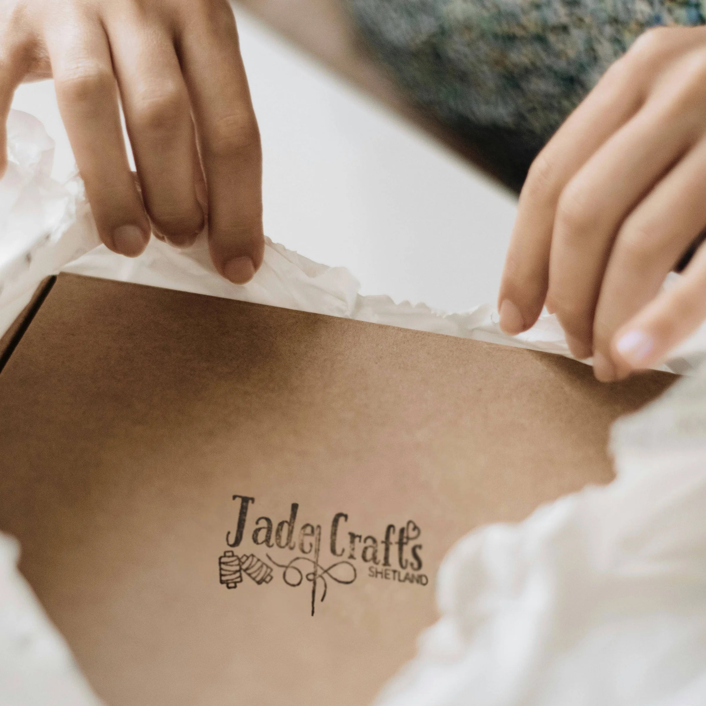 Person peeling off a packing with 'Jade Crafts' branding.