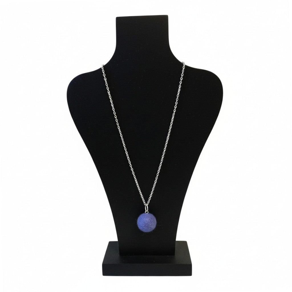 Hand felted blue wool ball pendant on a silver plated chain displayed on a black jewelry bust.