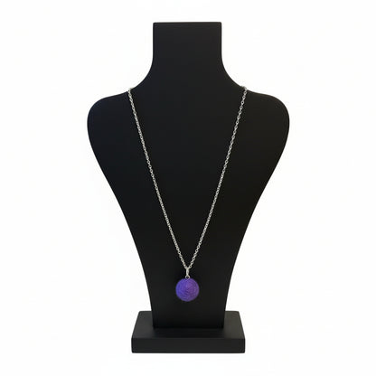 Hand felted purple wool ball pendant on a silver plated chain displayed on a black bust.