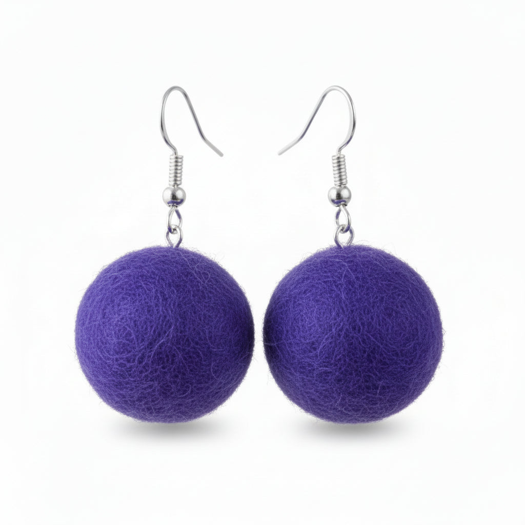 A pair of purple hand-felted wool ball earrings hanging from silver-colored metal hooks.