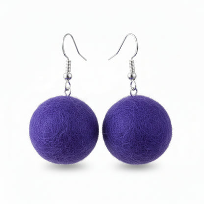 A pair of purple hand-felted wool ball earrings hanging from silver-colored metal hooks.