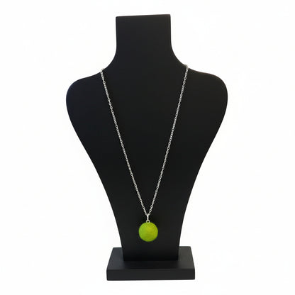 Hand felted lime green wool ball pendant on a silver plated chain displayed on a black bust.
