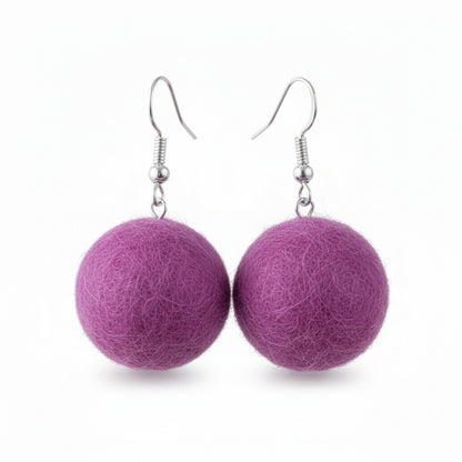 A pair of purple hand-felted wool ball earrings with silver-colored fishhook ear wires.