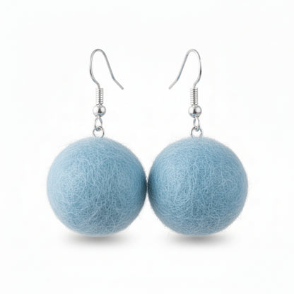 A pair of light blue hand-felted wool ball earrings with silver-colored metal hooks.