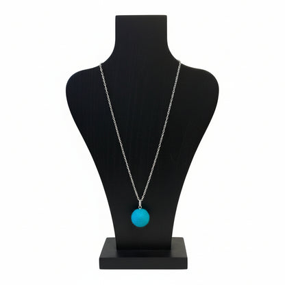 Hand felted wool necklace with a bright blue pendant on a silver-plated chain.